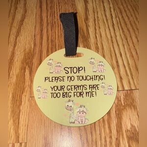 “No Touching” baby car seat sign